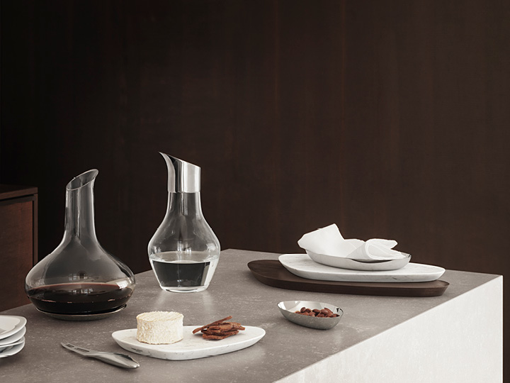 Sky Wine Carafe and Water Pitcher in handmade glass and stainless steel. Sky Serving Boards in marble and smoked oak. Sky Bowl small and medium in mirror polished stainless steel. Sky Cheese Knife in mirror polished stainless steel