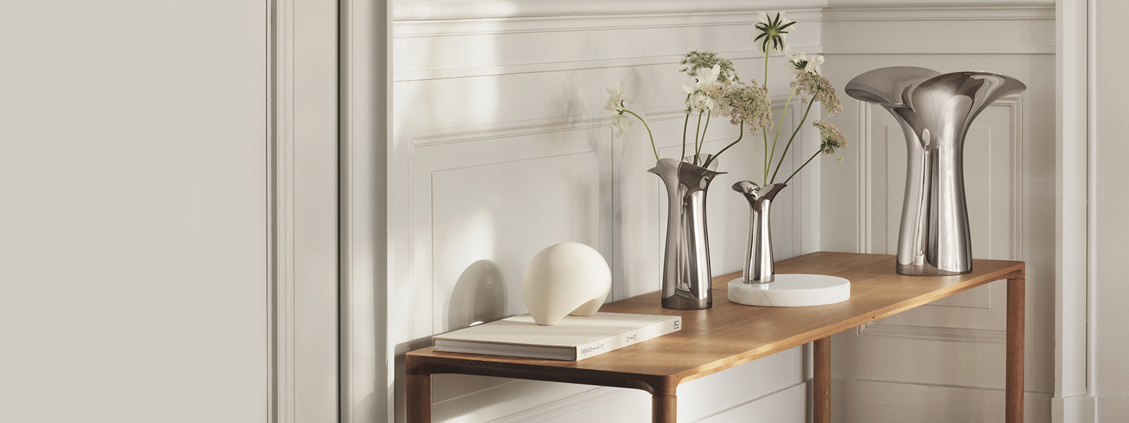 Mirror polished stainless steel flower inspired vases in small medium and large from the Bloom collection
