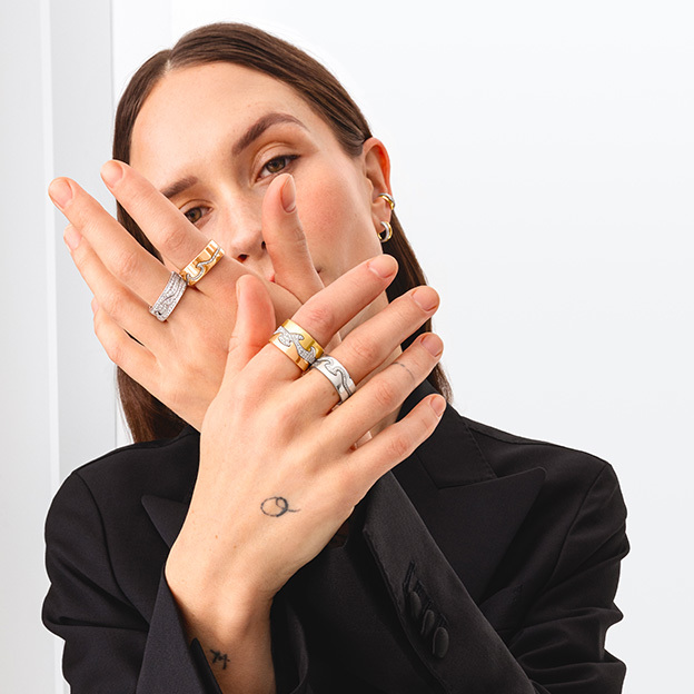 rings in 18 karat yellow white and rose gold with diamonds on hands from the fusion cloud collection by georg jensen