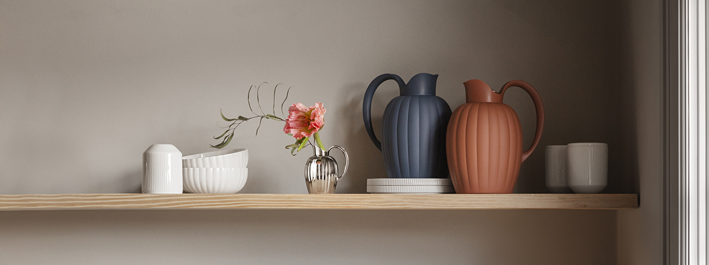 thermo jugs in terracotta and grey colours on kitchen shelf from the bernadotte collection designed by georg jensen