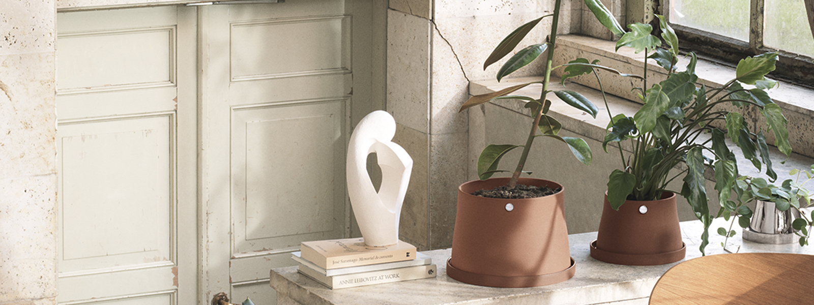 Pots and planters in terracotta and mirror polished stainless steel from the Terra collection by Norway design company Snøhetta and Georg Jensen