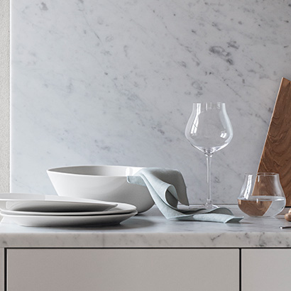 Crystal clear glasses and white porcelain plates from the Sky dining collection