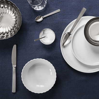 Still life tablesetting image of porcelain plates and bowls from the Bernadotte SS21 collection