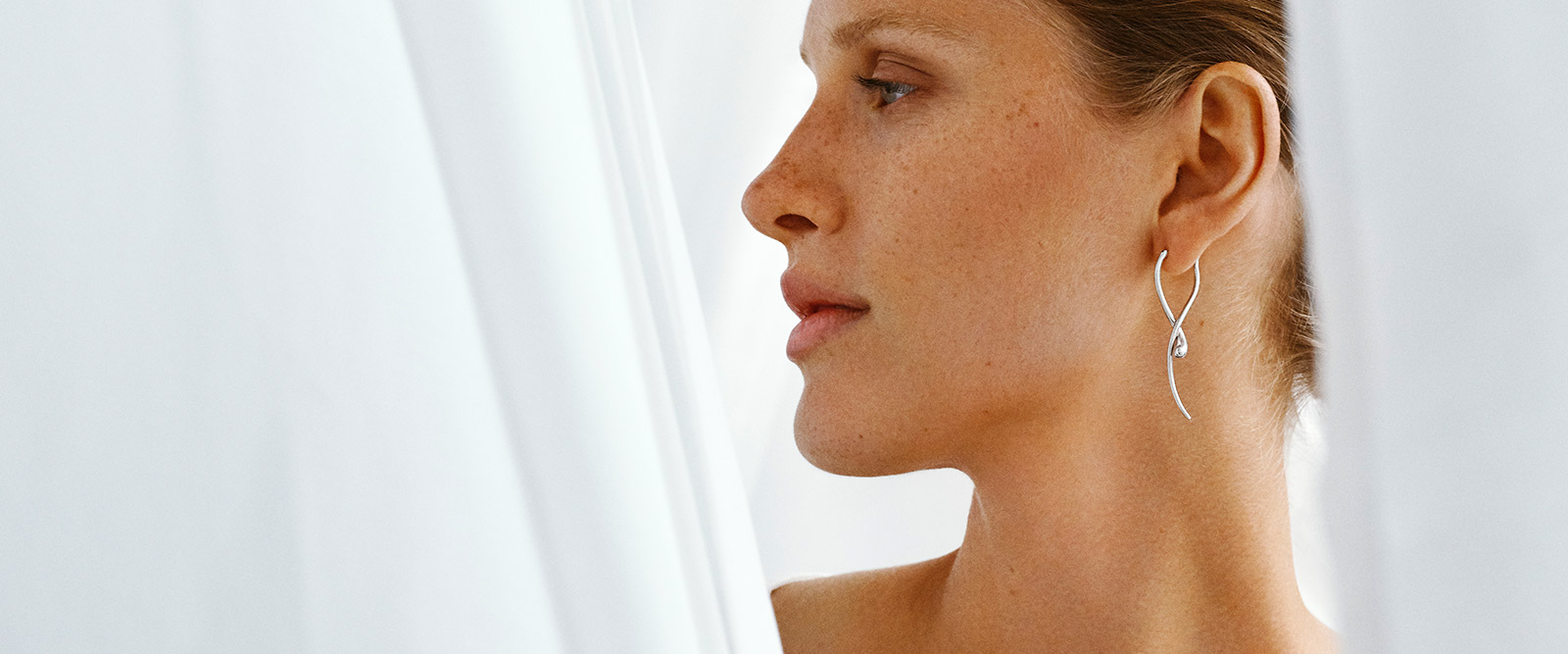 Earrings on model in sterling silver from the Mercy collection designed by Jacqueline Rabun