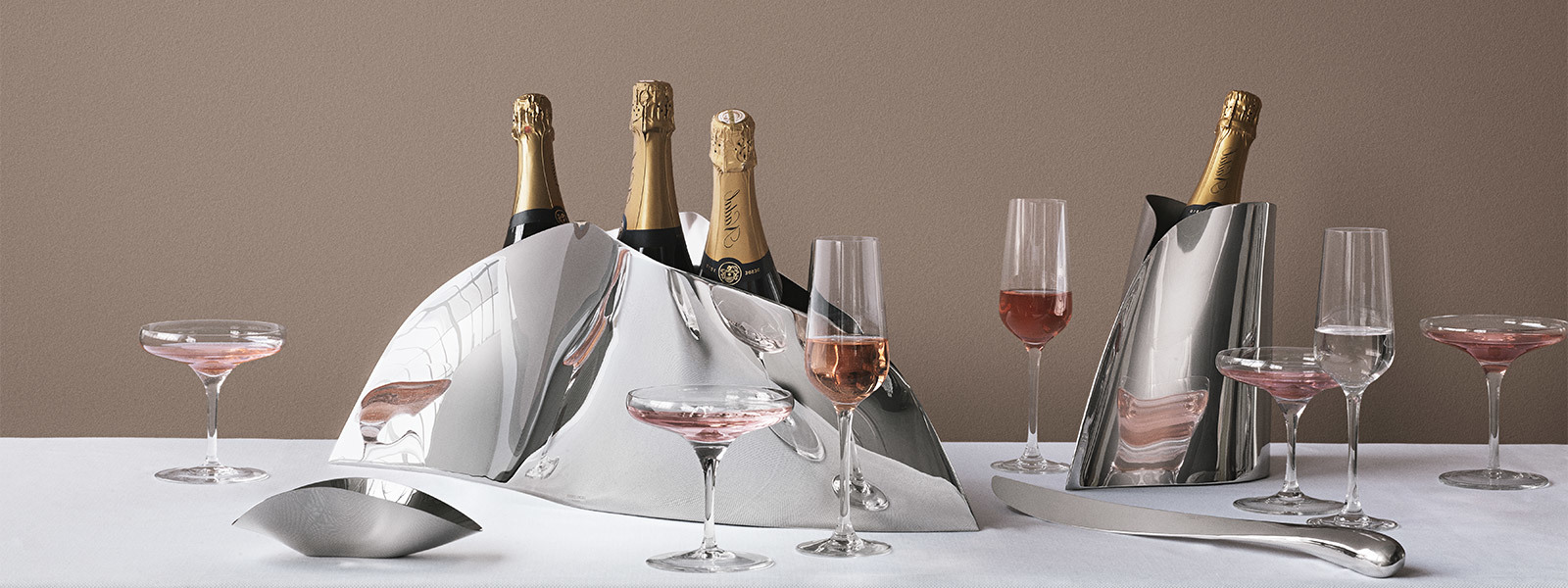 Still life image featuring mirror polished stainless steel Champagne coolers and sable from the Indulgence collection