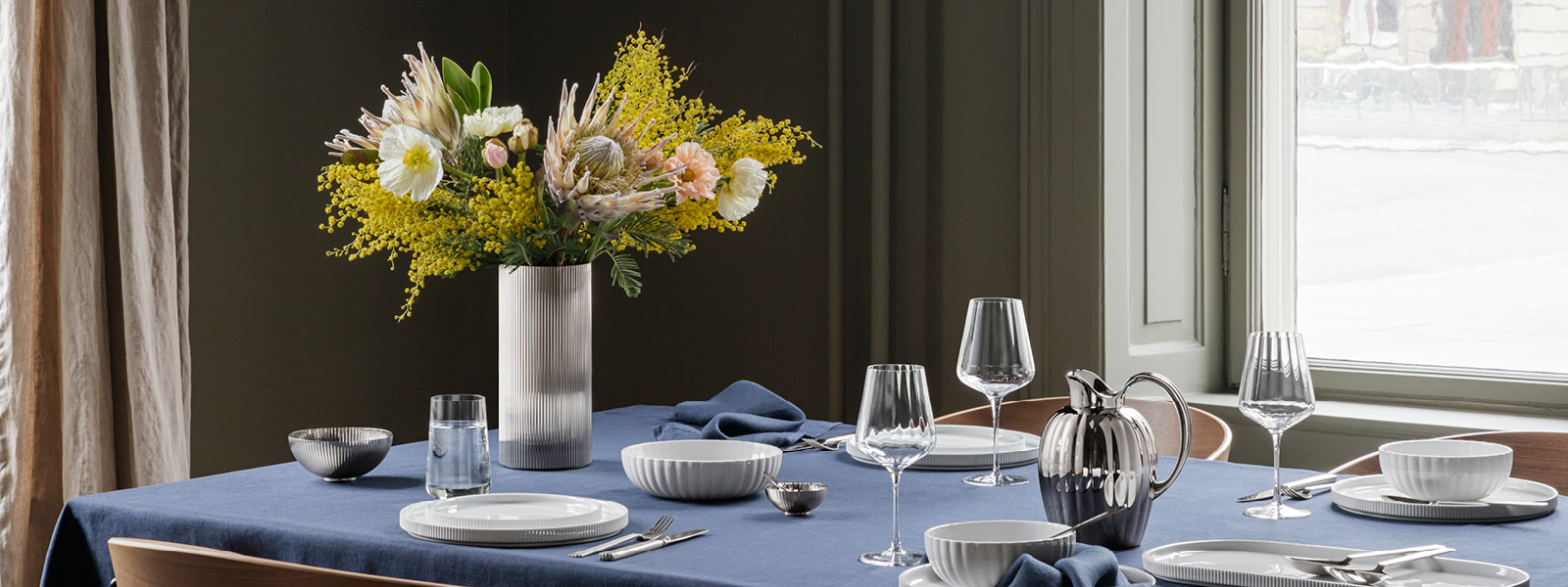 Bernadotte collection tablesetting in porcelain, mirror polished stainless steel and glass inspired by Sigvard Bernadotte