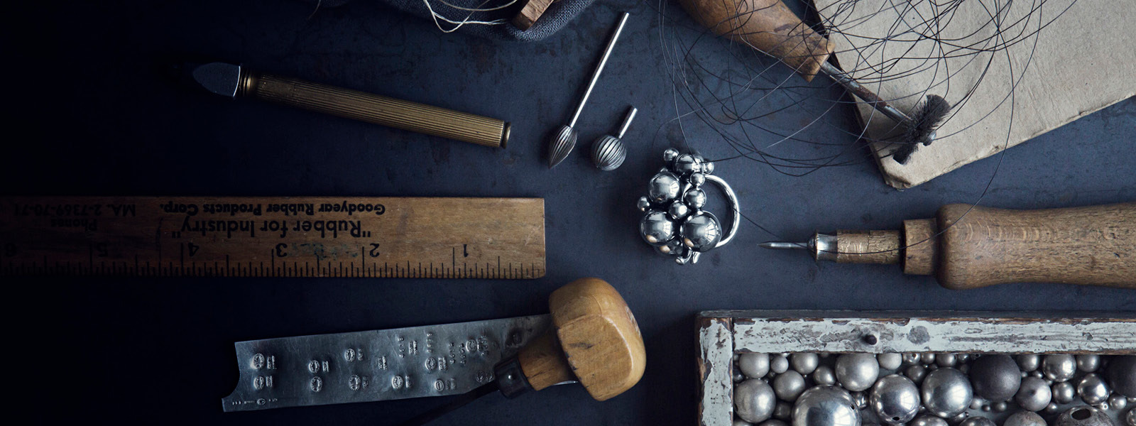 Oxidized sterling silver Moonlight Grapes collection ring in production with tools for craftsmanship