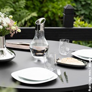 White porcelain plates and crystal clear glasses and water carafe from the Cobra collection