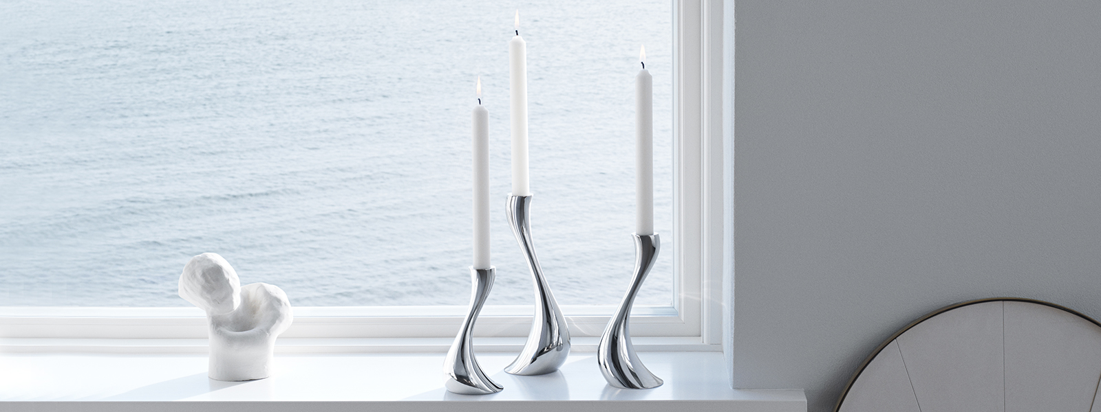 Mirror polished stainless steel candle holders from the Cobra collection