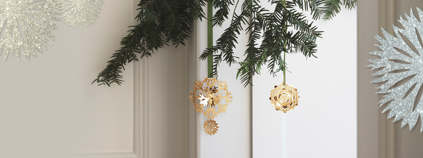 Christmas ornaments plated in 18 kt. gold from the Christmas Collectibles collection with green ribbon