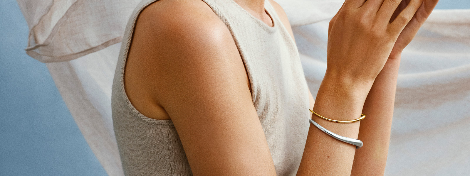 Sterling silver and 18 kr. gold bangles on model from the Offspring collection designed by Jacqueline Rabun