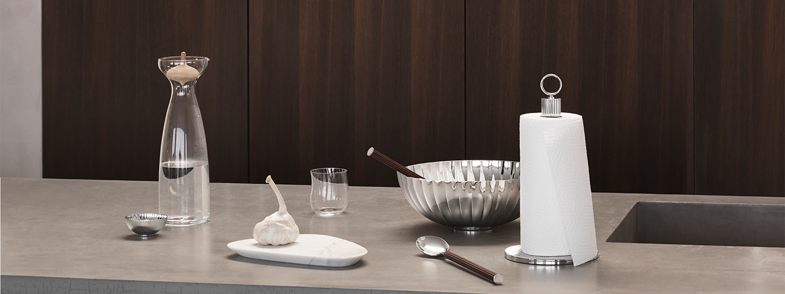 Mirror polished stainless steel and smoked oak kitchen role holder and salad servers from the Bernadotte collection inspired by Sigvard Bernadotte
