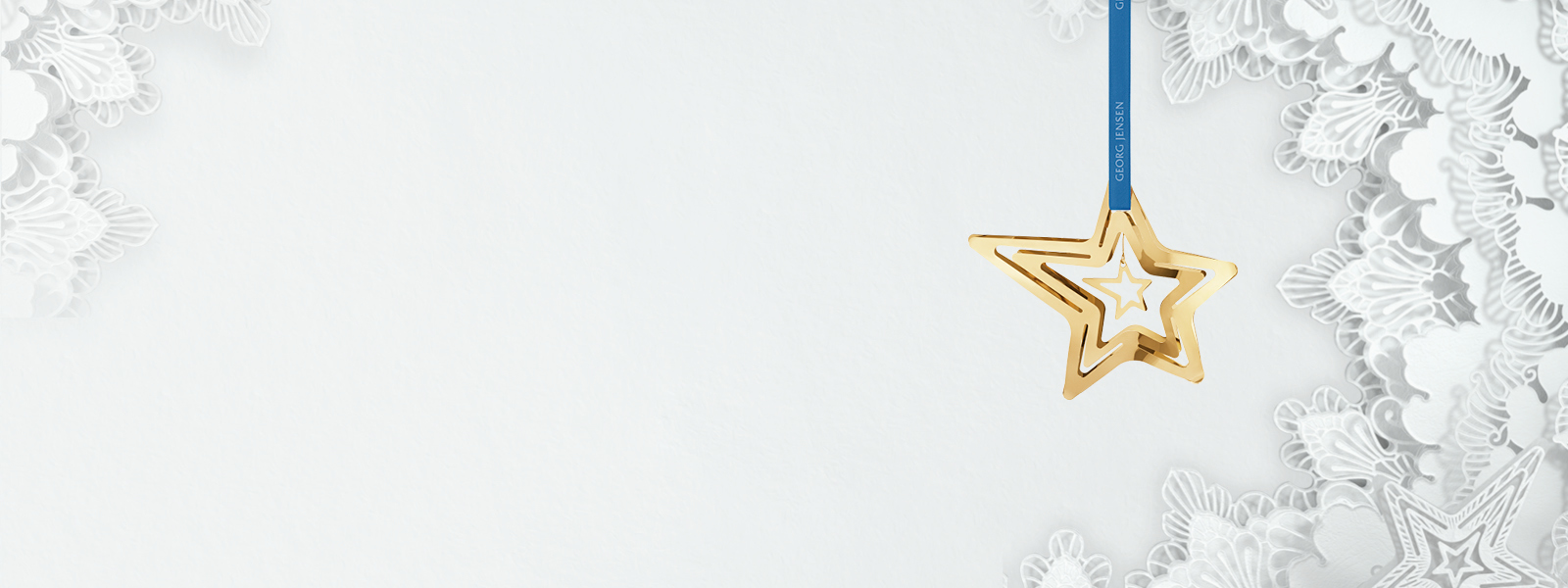 Christmas 2021 campaign banner featuring 18 kt. gold plated star shaped Christmas Ornaments designed by Georg Jensen