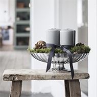 Mirror polished stainless steel bowl from the Bernadotte collection with candles