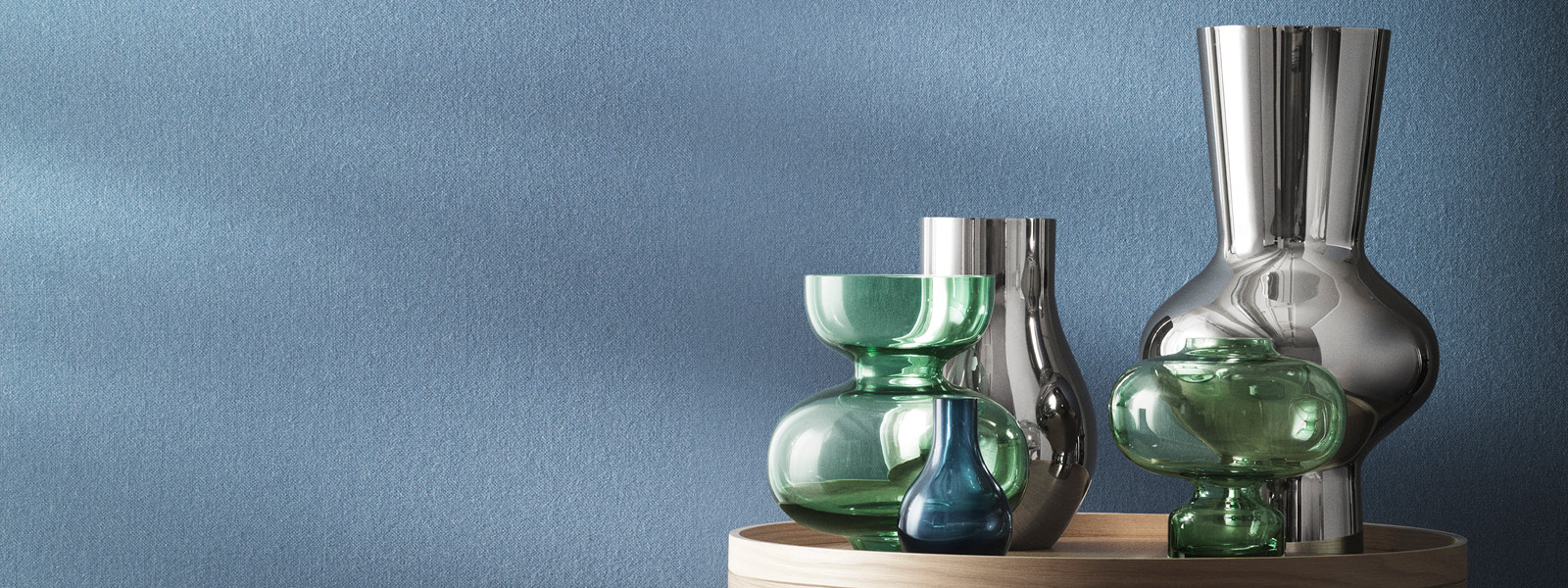 Mirror polished stainless steel and green glass vases from the Alfredo home collection