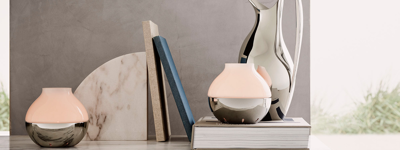 Mirror polished stainless steel and frosted glass candleholders from the Hurricane collection inspired by Henning Koppel