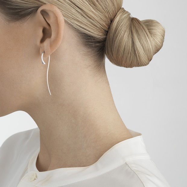 On model photo of sterling silver dangle earrings from Scandinavian jewellery brand Georg Jensen Mercy collection