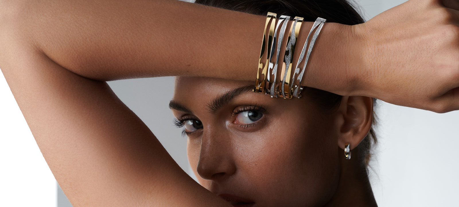 Georg Jensen Fusion collection bangles in 18kt yellow white gold with white diamonds and yellow white gold open bangle