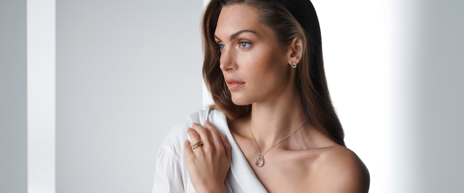 On model photo of Georg Jensen Offspring collection sterling silver pendant rings and earrings with diamonds