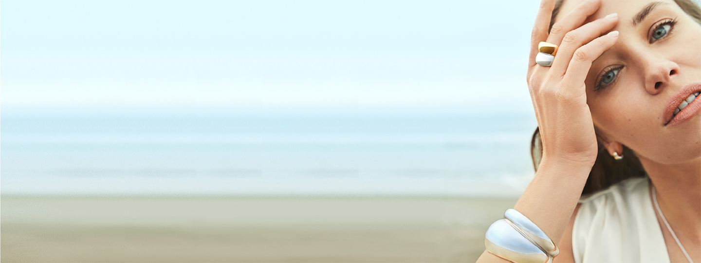 Sterling silver bangle and 18 kt. gold ring combination on model from the Curve collection designed by Regitze Overgaard