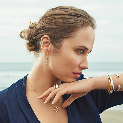 18 kt. gold and sterling silver rings, bangles, necklace with pendant and earrings from the Mercy collection designed by Jacqueline Rabun