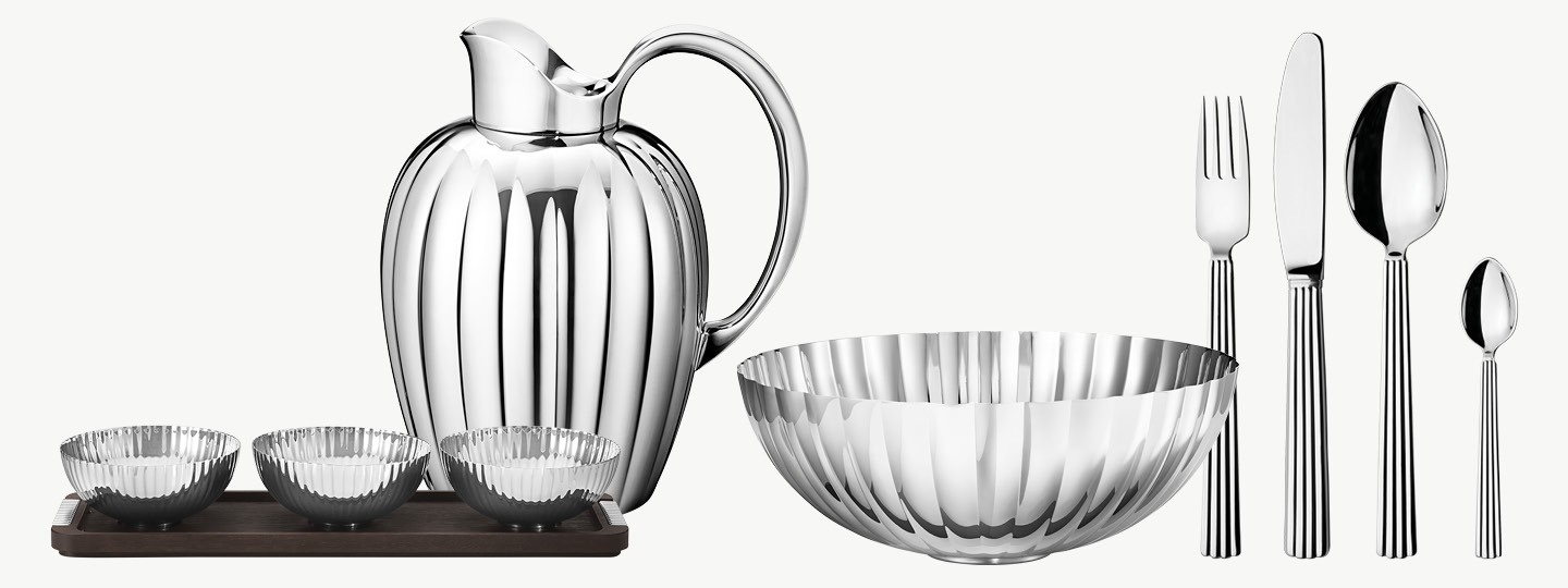 Bowls, carafe and cutlery in mirror polished stainless steel from the Bernadotte collection