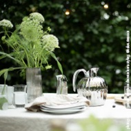 Mirror polished stainless steel and porcelain outdoor tablesetting featuring Bernadotte and Cobra collection