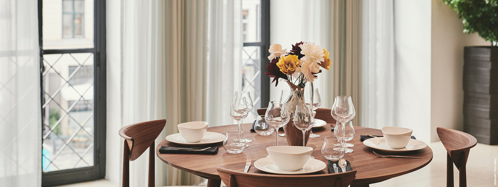 Sky table setting with wine glasses, tumblers, plates and bowls from Georg Jensen