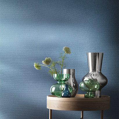 Composition of Georg Jensen Alfredo collection vases in light green mouth blown glass and mirror polished stainless steel 