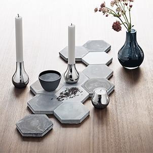 Mirror polished stainless steel and blue glass candle holders and vase from the Cafu collection