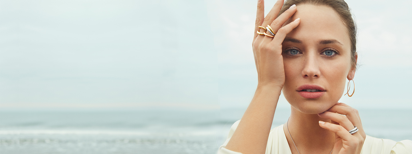 On model image of 18 kt. gold and sterling silver rings and earhoops from the Offspring collection designed by Jacqueline Rabun