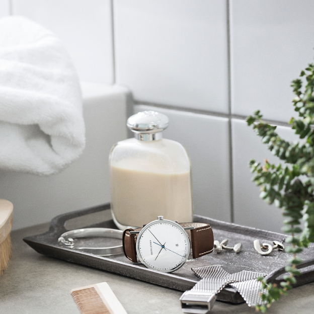 Mirror polished stainless steel watch with brown leather strap from the Koppel collection designed by Henning Koppel