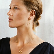 18 kt. gold necklace with pendant and earrings on model from the Mercy collection