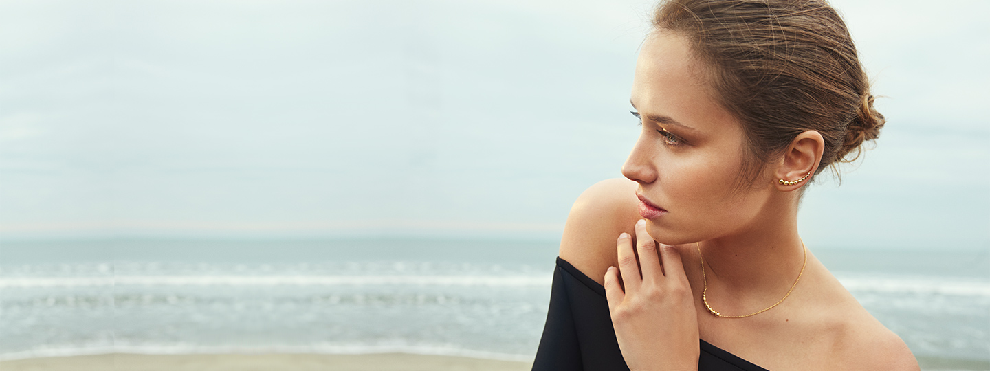 On model image featuring 18 kt. yellow gold grapes inspired necklace and earstuds from the Moonlight Grapes collection by Georg Jensen