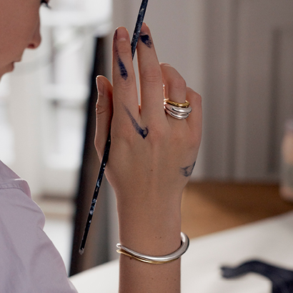 Christiane Spangsberg wearing bangles and rings in 18kt. gold and silver from our Offspring collection by Georg Jensen