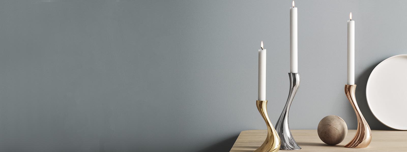 Candleholders in mirror polished stainless steel, plated rose gold and gold from the Cobra collection