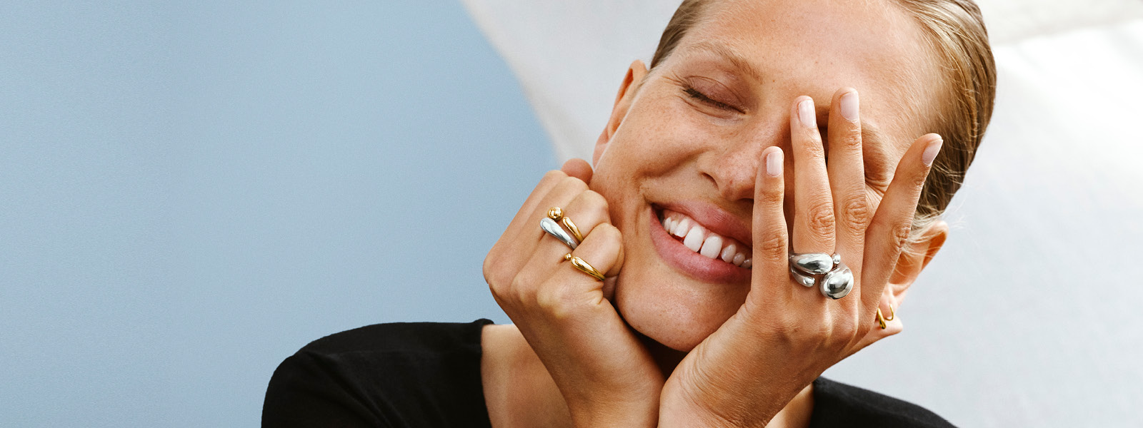 On model image of rings in sterling silver and 18kt. gold from the Mercy collection designed by Jacqueline Rabun