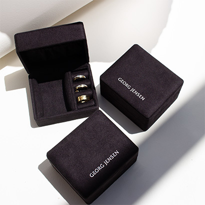 three small georg jensen jewellery boxes on white background