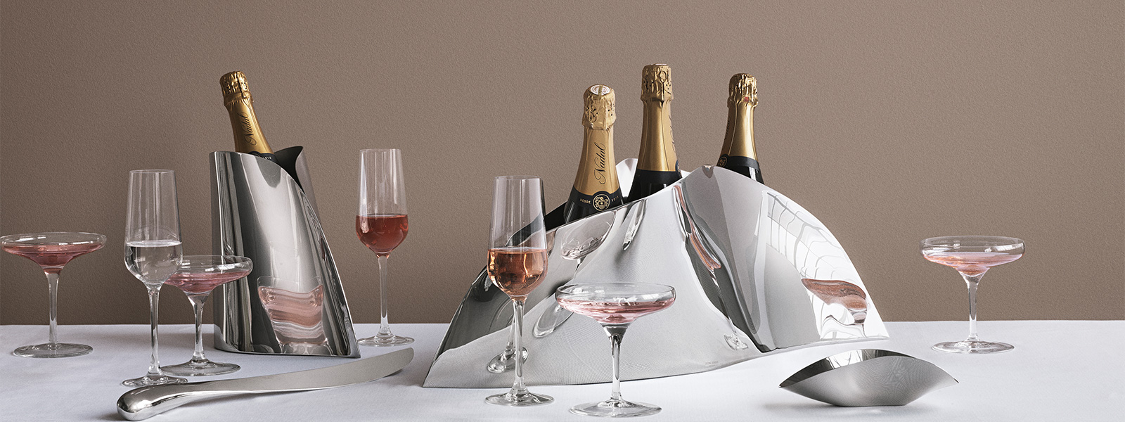 Still life image of mirror polished stainless steel Champagne coolers from the Indulgence collection designed by Helle Damkjær